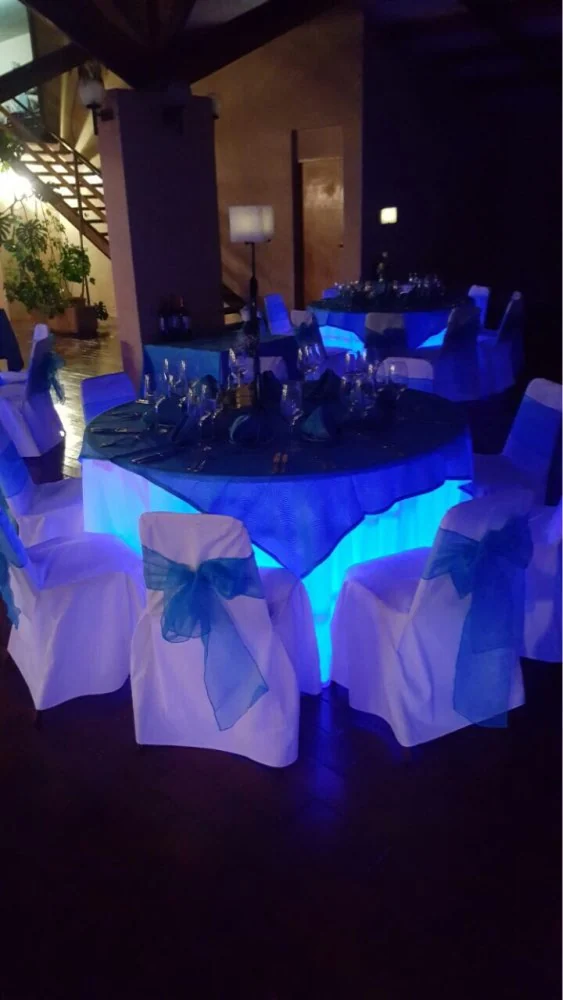 Customer feedback photo of a round wedding table glowing blue from an under-table LED light