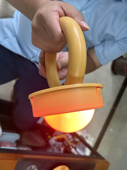Completed custom LED module illuminated inside its gold-coloured ring-handle housing