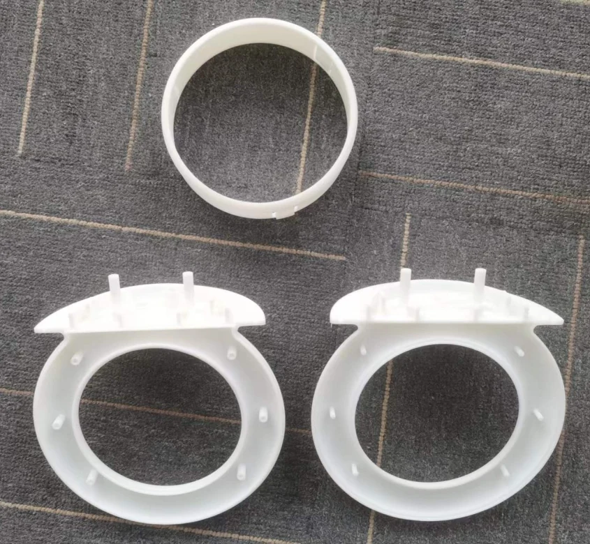 Separated white prototype parts for the second ring-handle and electronics-base solution