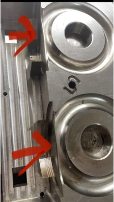 Actual metal mould from the custom ring-handle development with red review arrows