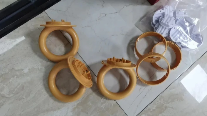 Gold-coloured ring-handle trial parts and separate base components arranged for inspection
