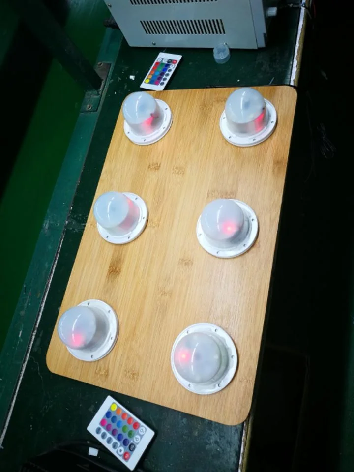 Six dome-shaped LED modules on a wooden six-position induction-charging board, with red indicators visible